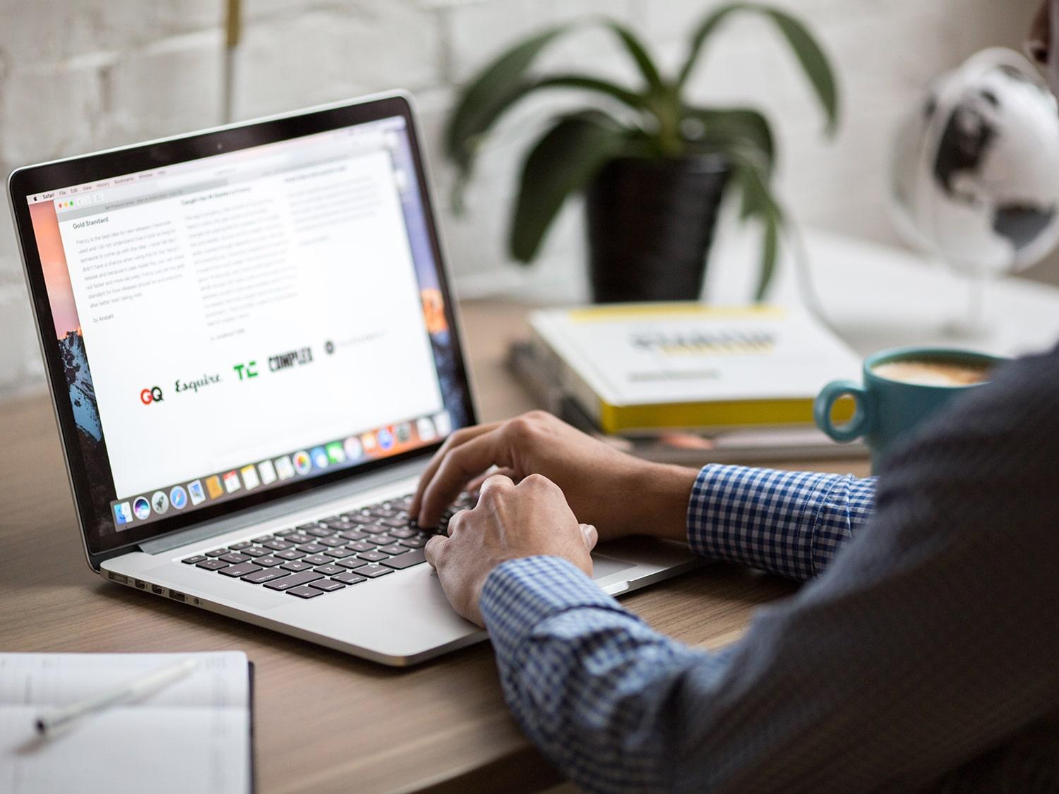 Lawyer sitting at desk while checking emails on his computer