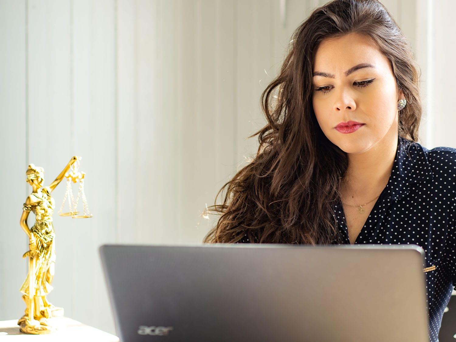 Female lawyer sitting at her desk doing some work at her computer