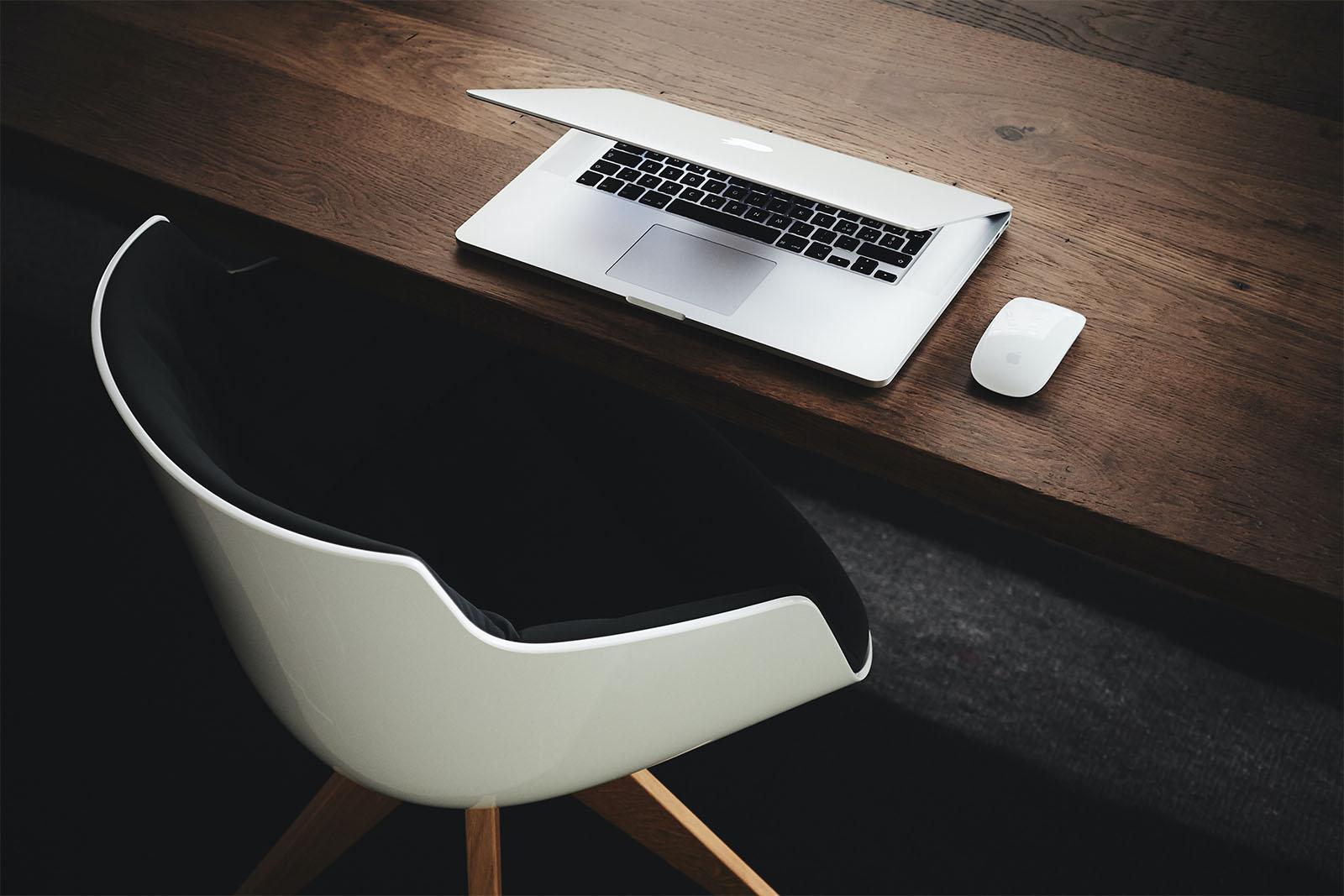 Lawyer's chair next to a table with a computer on top of it